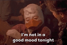 a duck with a mask on says " i 'm not in a good mood tonight "