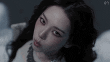 a close up of a woman 's face in a dark room