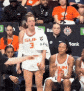 a basketball player with the number 3 on his shirt stands in front of a crowd