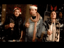 a group of people are standing next to each other holding glasses of wine .