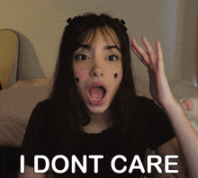 a girl with stars on her face is making a face and says i dont care