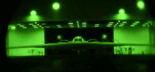 a plane is parked in a hangar with a green light behind it .