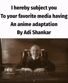 a judge is sitting at a desk in a courtroom giving a speech .