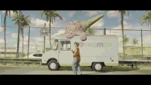 a man stands in front of an ice cream truck that says dynamite on it