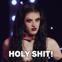 a drag queen says holy shit while wearing a red collar