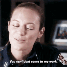 a woman in a firefighter uniform is talking to someone and says you can 't just come to my work .