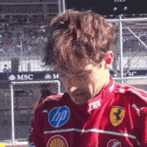 a man wearing a red shirt with an hp logo