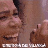 a close up of a person 's face with the words energia de vilmoca written below it
