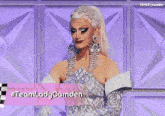 a drag queen with the name lady camden on a pink sign