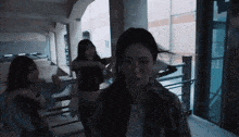 a group of women are dancing in a dark room with the number 11 in the background