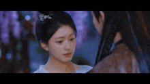 a man and a woman are standing next to each other in a room .
