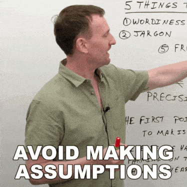 a man is pointing at a white board with the words 