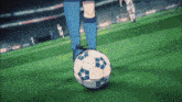 a soccer player in blue socks is kicking a soccer ball