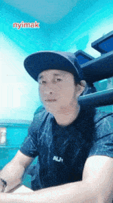 a man wearing a baseball cap and a shirt that says auy
