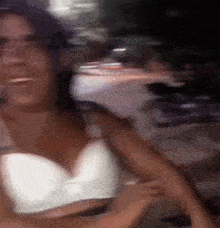 a blurry picture of a woman wearing a white bra