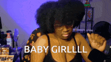 a woman wearing glasses and a bra says baby girlll