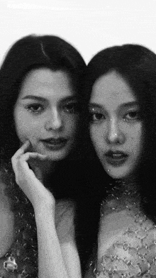two women are standing next to each other and one has rhinestones on her face