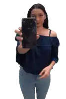 a woman in a blue off the shoulder top is holding up a broken iphone