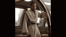 a man with a beard in a robe stands in a doorway