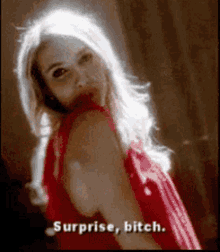 a woman in a red dress says surprise bitch .