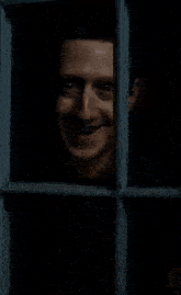 a man peeking out of a window with the words " try our new " in red