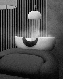 a black and white photo of a sink with steam coming out of it in a bathroom