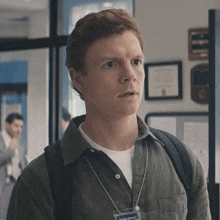 a man wearing a name tag that says frank metro on it