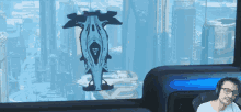 a man wearing headphones looks out of a window at a futuristic scene