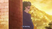 a man leaning against a brick wall with the words i 'm leaving above him