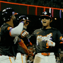 a baseball player wearing a giants jersey celebrates