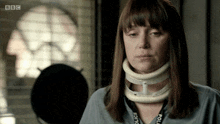 a woman wearing a neck brace and a bbc lanyard