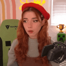 a woman with red hair is wearing a red beret and holding a microphone .