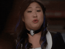a woman wearing a black choker and a cameo necklace