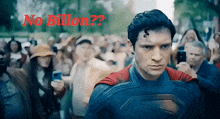 a man in a superman costume stands in front of a crowd with the words " no billion " behind him