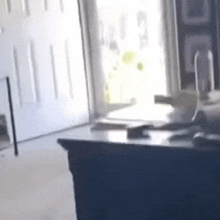 a blurred image of a desk in front of a window with a phone on it .