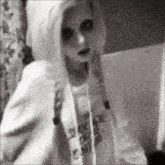 a black and white photo of a woman in a hoodie with a hood .
