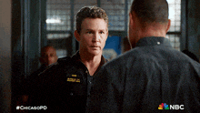 two men are standing next to each other with the hashtag #chicagopd on the bottom