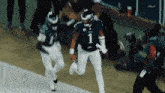 a football player with the number 1 on his jersey is running on the field