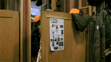a wooden door with a flyer on it that says hunting