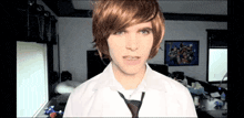 a young man wearing a white shirt and tie is making a funny face