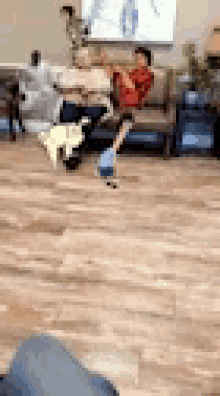 a blurry picture of a person sitting on a couch in a waiting room with a dog .