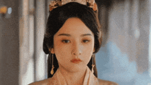 a close up of a woman 's face with a crown on her head .