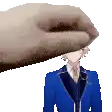 a pixel art of a hand holding a man 's head in a blue suit .
