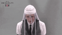 a man with a bandage on his head is wearing a white shirt and tie
