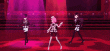three anime girls are dancing on a stage in front of a red background .