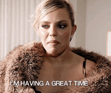 a woman is wearing a fur coat and says i 'm having a great time