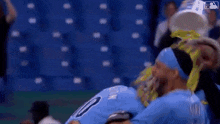 a baseball player is being helped off the field by a nurse .