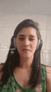 a woman wearing headphones has tiktok written on the bottom