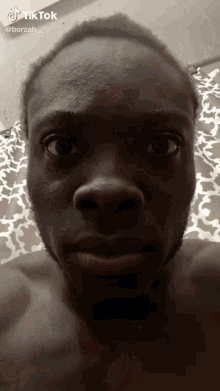 a close up of a man 's face with a tiktok logo on the bottom