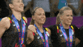 three female athletes with medals around their necks and the word belgium on their shirts